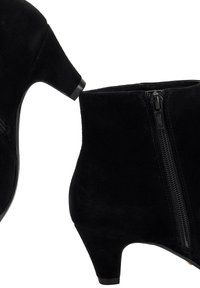 Black suede ankle boots with low block heels and side zippers, showing both lateral and sole views.