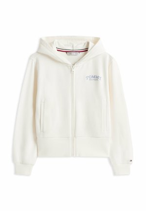 Sweatshirt à fermeture éclair blanche en matériau doux, avec capuche, poignets côtelés et un petit logo bleu "TOMMY HILFIGER" sur la poitrine.