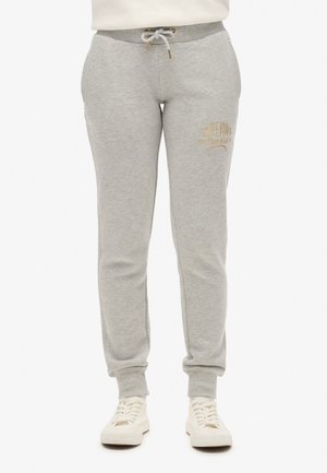 Lichtgrijze sweatpants van zacht materiaal, met een verstelbare tailleband, zijzakken en een in het goud gegraveerd logo.