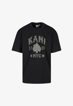 Fekete, rövid ujjú pamut póló, amelyen merész szürke grafikus feliratok találhatók: "KANI", "1989" és "NYC", valamint egy kártyaáspóker és csillagok mintázata.