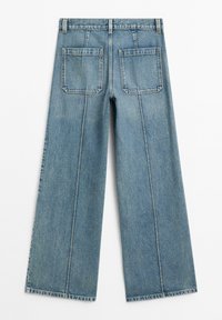 Light blue denim wide-leg jeans with a high waist, featuring two back pockets and visible stitching along the seams. Clean finish.