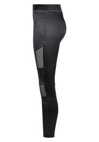 Zwarte leggings van een gladde, stretchstof met meshpanelen aan de zijkanten, wat zorgt voor een aansluitend design en een moderne uitstraling.