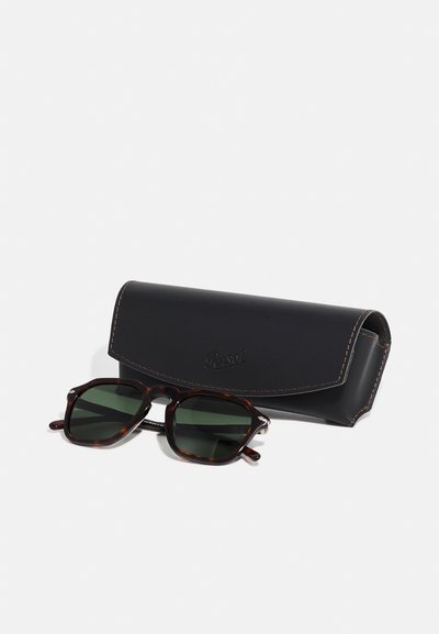 Square sunglasses with dark green lenses and a tortoiseshell frame, accompanied by a black leather case with stitched detailing.