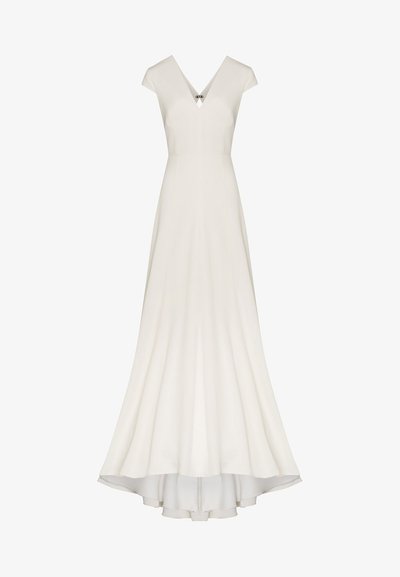 Robe blanche à manches courtes avec un décolleté en V, une jupe évasée et une longueur asymétrique. Présente unélément décoratif au niveau du col. Texture de tissu lisse.
