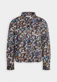 Chemise à manches longues avec col à boutons, fond sombre, et motif floral vibrant en blanc, turquoise, orange et violet.