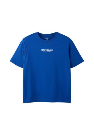 T-shirt bleu manches courtes avec texte blanc "ACTIVE STUDIO" et script plus petit en dessous centré sur la poitrine, fond uni.