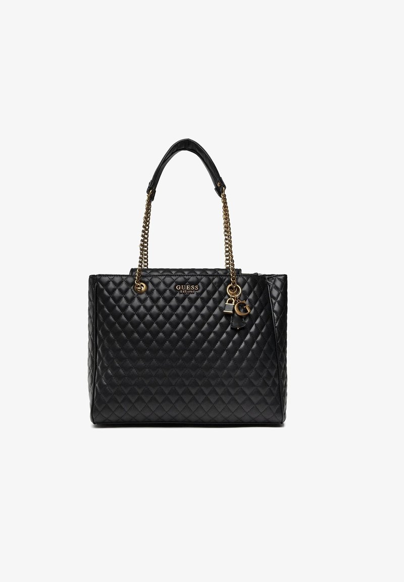 Sac à main en cuir matelassé noir avec poignées chaînes dorées, logo Guess, et breloques décoratives en forme de cadenas et clé dorés.