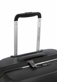 Black hard-shell suitcase with a textured surface, aluminum handle, and combination lock. Features a sleek, modern design.