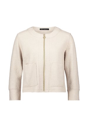 Veste zippée beige clair en tissu texturé, avec un col rond, deux poches avant et une fermeture éclair dorée.
