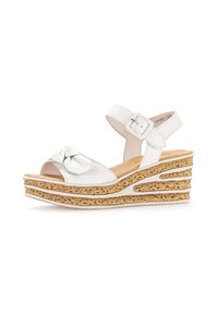 White leather wedge sandal with a bow accent, adjustable ankle strap, and cork-like textured platform featuring cut-out designs.
