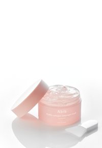 Barattolo di plastica rosa con gelatina trasparente all'interno, etichettato "Abib PDRN collagen overnight mask." Include una spatola applicatrice bianca.