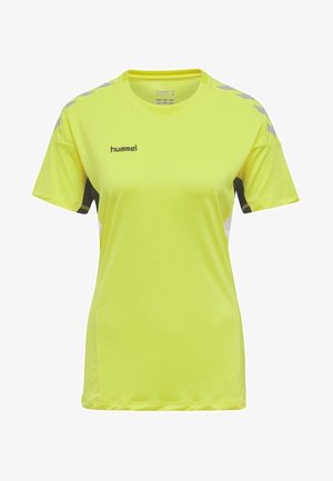 Lyhythihainen, kirkkaan keltainen urheilupaita mustilla yksityiskohdilla ja harmailla oikeakulmaisilla kuvioilla hartioissa. Valmistettu kevyestä, hengittävästä materiaalista.