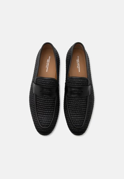 Μαύρα υφασμένα δερμάτινα loafers με λείο λουράκι στην κορυφή, ταμπά ενδοσόλτες και στρογγυλεμένες μύτες τοποθετημένα δίπλα-δίπλα σε λευκό φόντο.