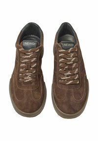 Brown suede sneakers with textured surface, featuring beige laces and a dark gray rubber sole. Brand logo visible on the insole.
