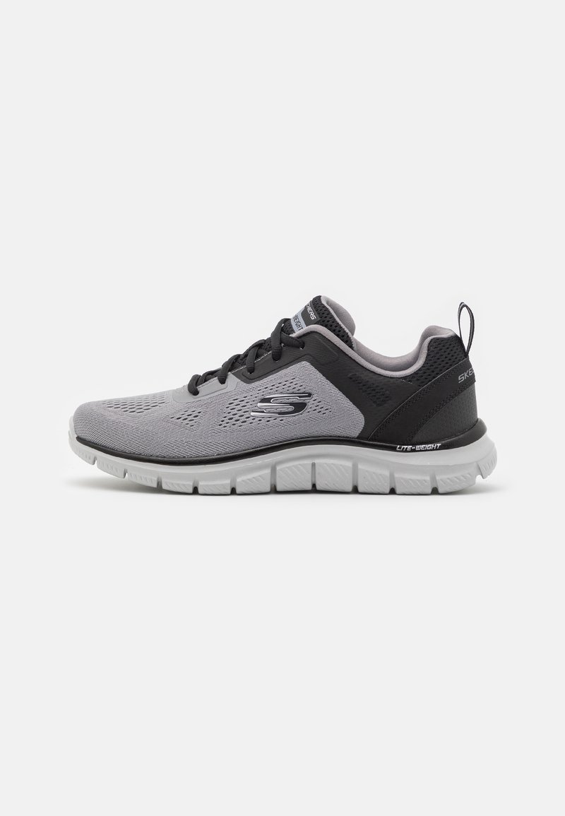 Gray and black athletic shoe with mesh upper, lace closure, lightweight cushioning, and textured sole for traction.