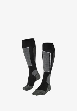 Kniestrümpfe in Schwarz und Grau mit strukturiertem Design, gepolsterten Abschnitten und kontrastierenden Mustern an den Seiten und Zehen.