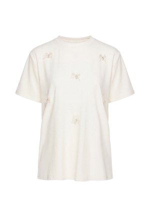 Kortærmet cremefarvet T-shirt med små gennemsigtige stofsløjfer og perleaccenter spredt på forsiden.