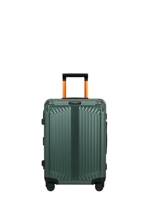 Hard-shell dark green suitcase with vertical grooves, four black wheels, and an extended orange and black telescopic handle.