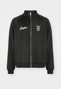 Sort lynlåsjakke med ståkrave, med hvid "Benfica" tekst og et broderet emblem på brystet. Fremstillet i glat stof.