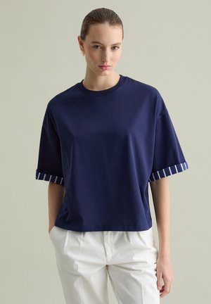 Navy blue cotton t-shirt with a crew neck and short sleeves featuring striped accents at the cuffs. Relaxed fit and smooth texture.