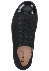 Black sneaker with a suede upper, glossy black toe cap, lace-up design, and minimalistic stitching. Interior features a beige insole.