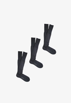 Tre paia di calzini a coste grigio scuro fino al ginocchio disposti su uno sfondo bianco, ogni paio affiancato con la scritta "PEROFIL" sul piede.