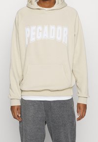 Pegador Jersey con capucha - beige