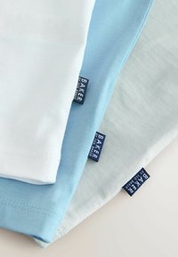 Drei T-Shirts in Hellblau, Weiß und Blassblau, mit Stoffetiketten mit "BAKER"-Logo, glatter Textur und kurzen Ärmeln.