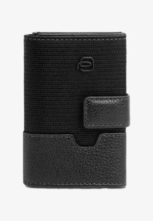 Black wallet featuring a textured fabric upper and a smooth leather bottom. Closed with a snap button, with a logo embossed on the front.
