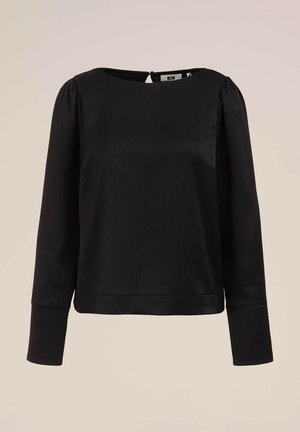 Črna bluza z dolgimi rokavi in okroglim izrezom, teksturirana tkanina in subtilne navpične črte. Ima zapiranje na gumb na hrbtu in prilegajoč kroj.