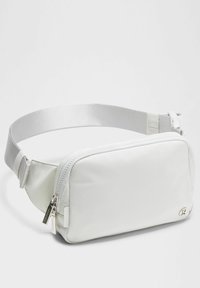 White synthetic hip bag with a smooth texture, zip closure, and adjustable strap. Features logo and minimalistic design.
