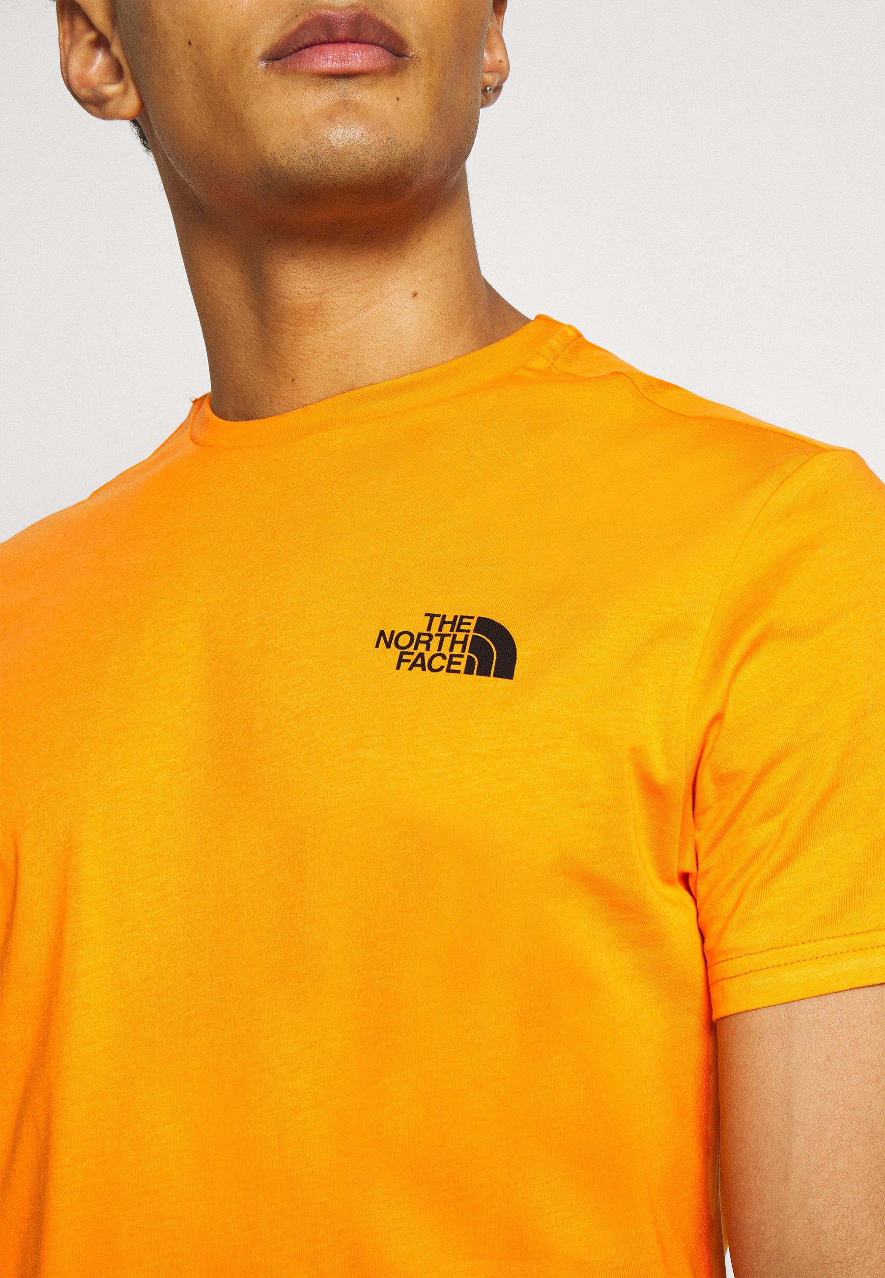 orange north face shirt