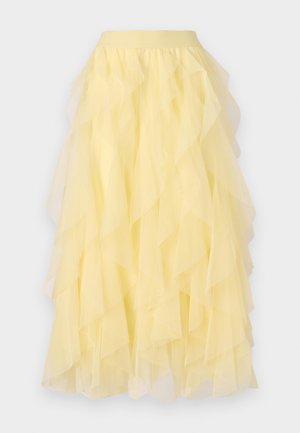 Gulvet nederdel laget av gjennomsiktig tull, med en vid silhuett og overlappende volanger samt et elastisk liv.