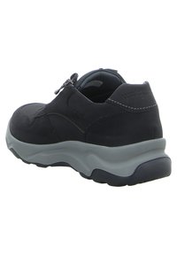 Dark blue suede sneaker with a gray rubber sole, featuring a side zipper and contrast stitching on the upper for added detail.