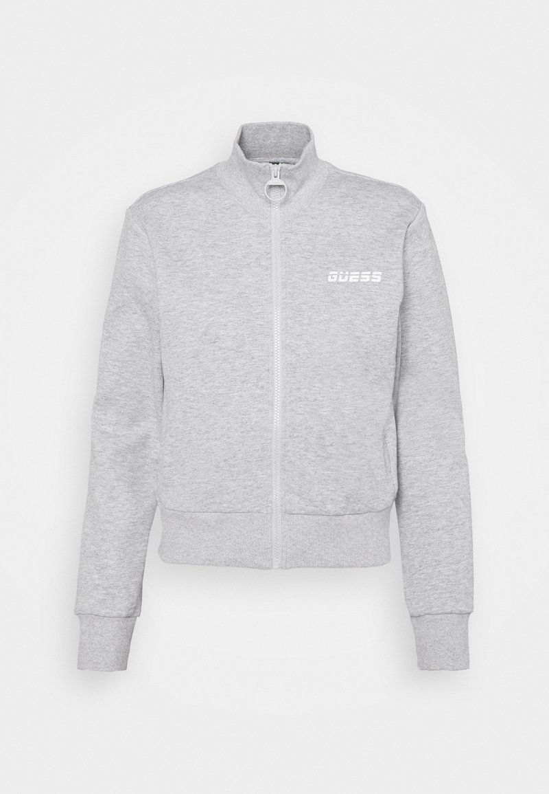 Sweat-shirt gris clair zippé avec col montant, poignets et ourlet côtelés, et logo blanc "GUESS" sur le côté gauche de la poitrine.