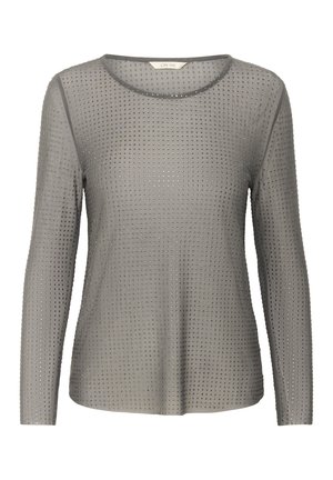 Pikad varrukad, hall blouse, ümmarguse kaelusega, millel on tekstuuritud muster metallist nupud, mis on ühtlaselt jaotatud kangale.