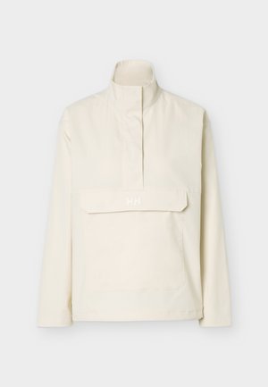 Elfenbeinfarbener Pullover mit hohem Kragen, Frontreißverschluss unter Blende und großer Fronttasche mit dezentem "HH"-Logo auf der Blende.