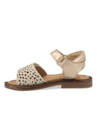 Leather sandals featuring a spotted textile upper in cream and brown, with a metallic gold ankle strap and flat sole.