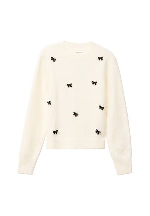 Suéter crema con cuello redondo, mangas largas y adornos de lazo negro distribuidos uniformemente en la parte delantera. Tejido suave y texturizado.