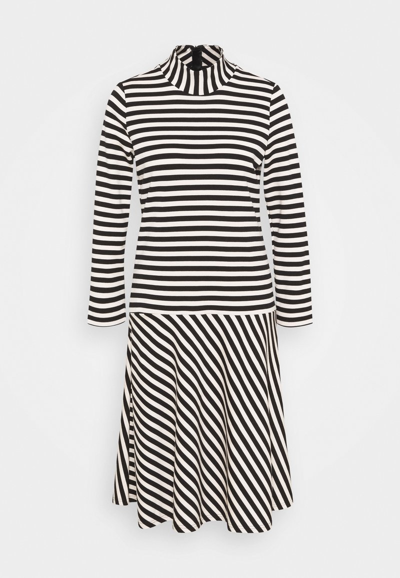 Svart och vit randig långärmad klänning med hög halsringning och utsvängd kjol, med diagonala ränder på den nedre halvan.