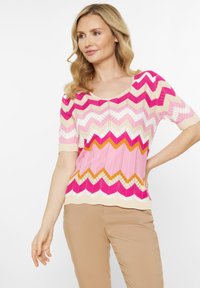 Suéter de punto con un patrón en zigzag en tonos de rosa, fucsia y naranja, con mangas cortas y un escote amplio. Texturizado y ligero.