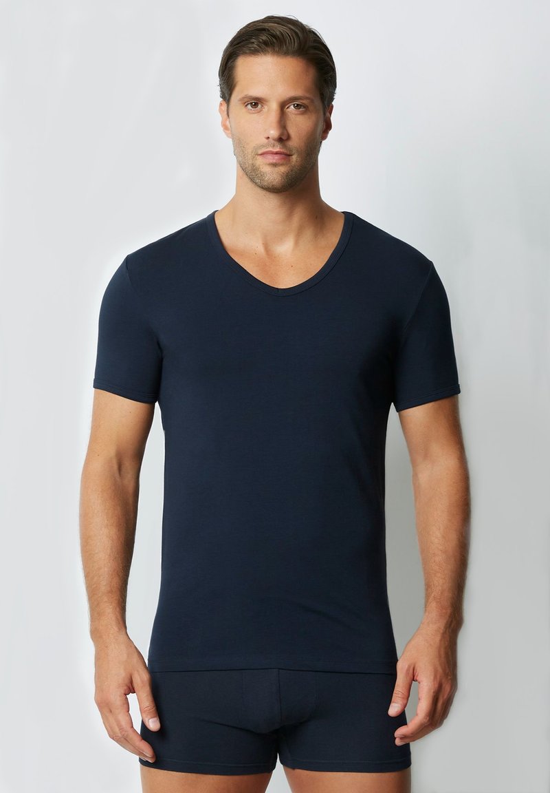 Navy blue short-sleeve V-neck t-shirt made of smooth fabric, form-fitting design, with matching navy shorts.