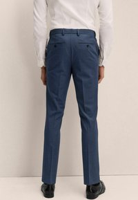 Herren-Hosenträger aus dunkelblauem Stoff, mit slim fit, zwei Gesäßtaschen mit Knopfverschluss und glatter Textur.