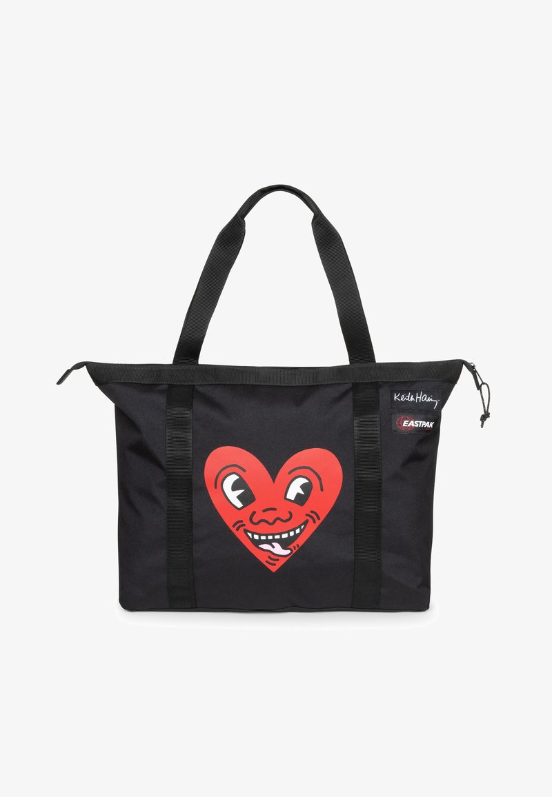 Sac fourre-tout noir arborant un grand motif de cœur rouge avec un visage souriant. Fabriqué en tissu durable, il dispose de deux poignées solides et d'une fermeture éclair.