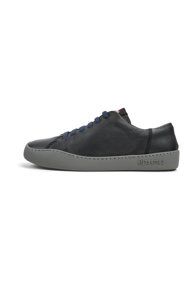 Black leather sneaker with a smooth texture, gray rubber sole, navy blue laces, and subtle branding on the heel. Rounded toe design.