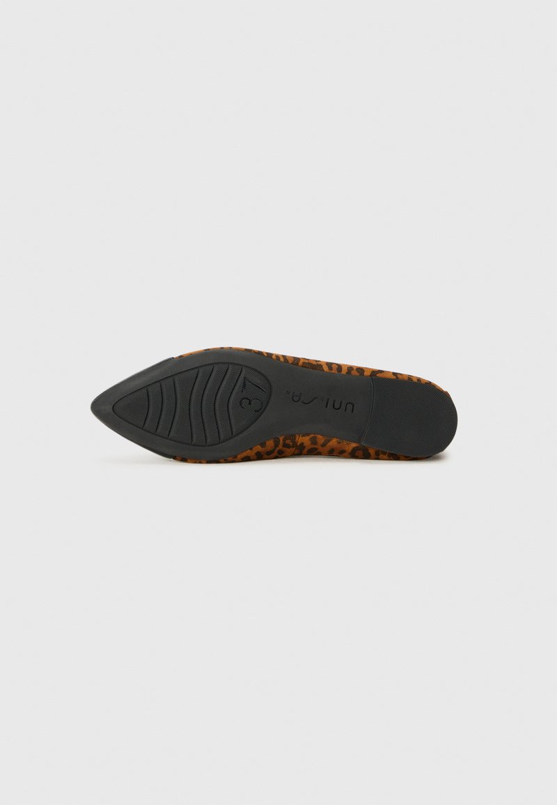 Zapato de tacón alto con estampado de leopardo, punta afilada, suela de goma negra y detalles texturizados. La suela presenta patrones de agarre para mejor tracción.