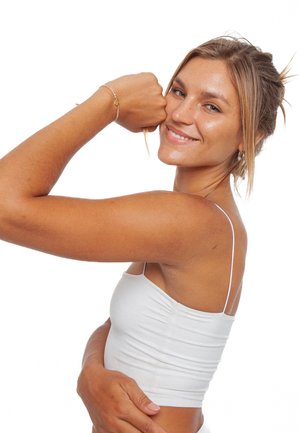 Weißes, tailliertes Tanktop mit dünnen Trägern; das Model hat hellbraune Haut und trägt ein zartes Armband, während es ihren Arm anspannt. Der Hintergrund ist schlicht weiß.