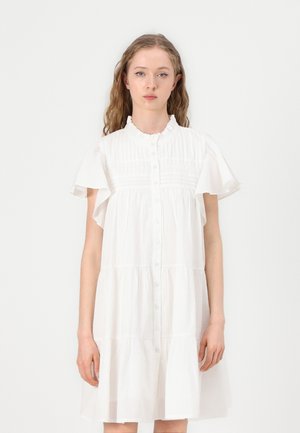 White cotton dress with short ruffled sleeves, button front, and tiered design, featuring horizontal pleats along the bodice.