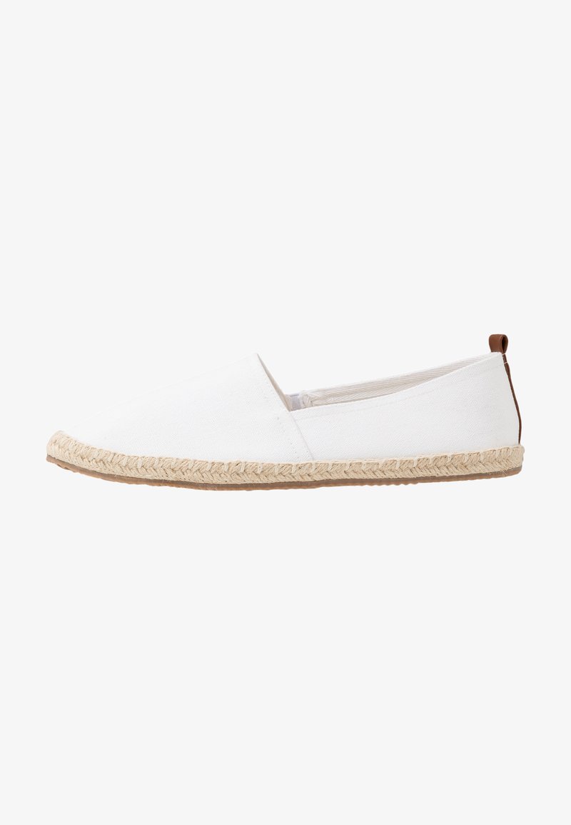White canvas slip-on shoe with a pointed toe and braided jute sole. Features a small brown accent at the heel. Lightweight and breathable design.