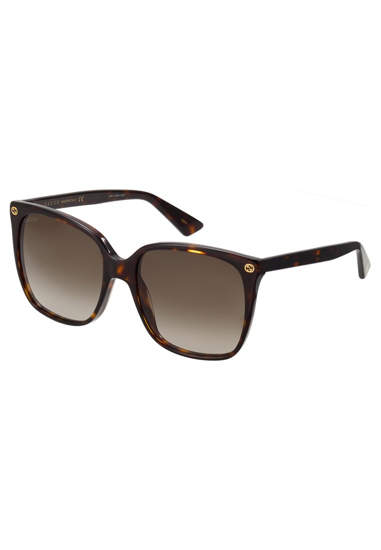 Ochelari de soare din material tortoiseshell, cu lentile mari în formă pătrată, nuanțe de maro cu degrade și detalii aurii cu logo pe braț. Ramă din plastic, finisaj lucios.